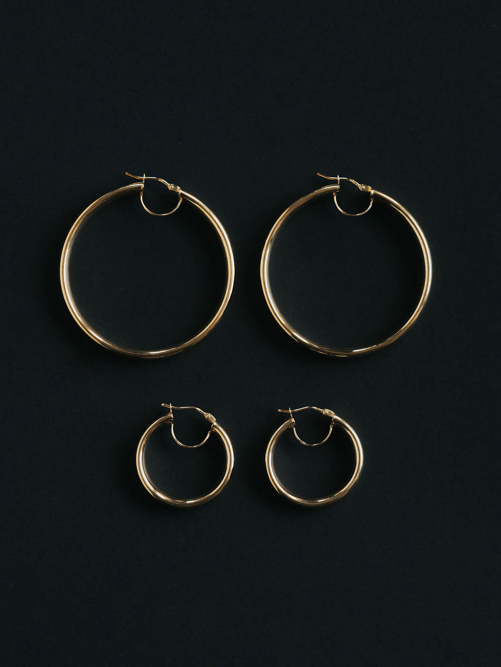 9ct yellow gold court tube hoops, worn