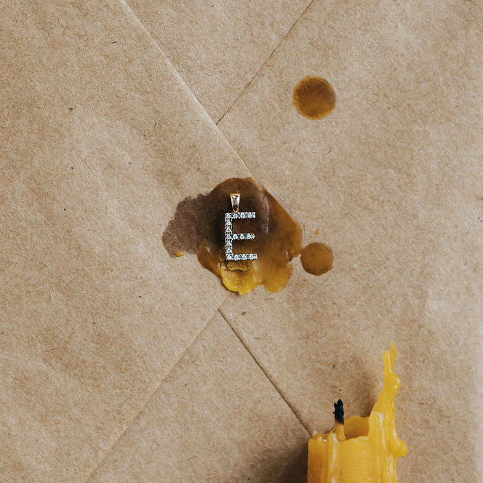 Diamond initial pendant necklace in 9ct yellow gold, close up on chain