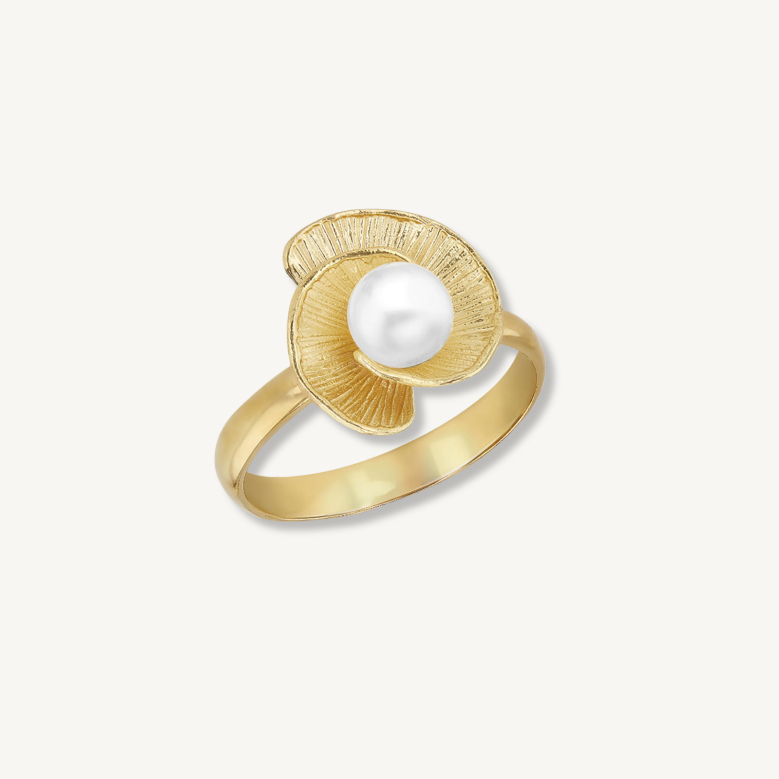 Gold ring with a textured design on a light gray background