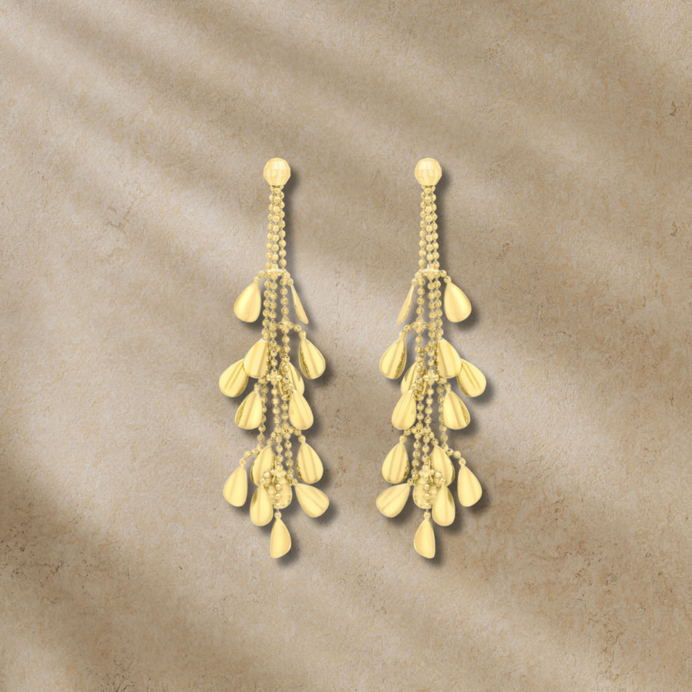 Gold earrings on a textured beige background