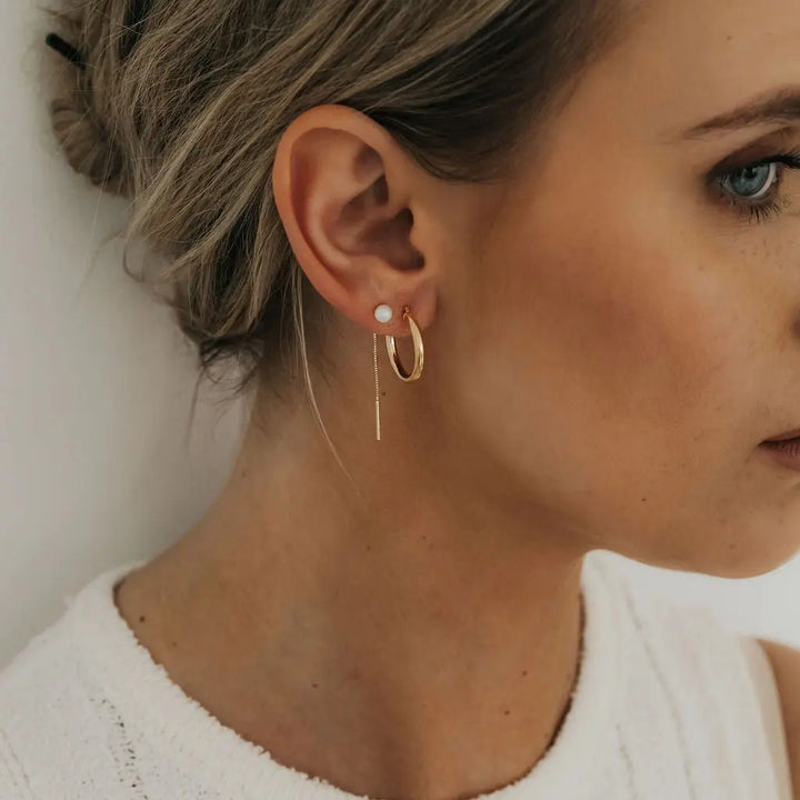 Solid 9ct yellow gold 20mm tube hoop earrings on ear