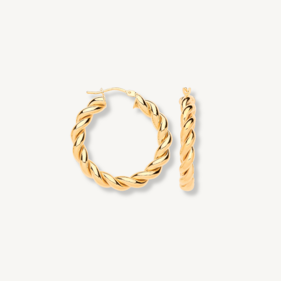 Pair of gold hoop earrings on a white background