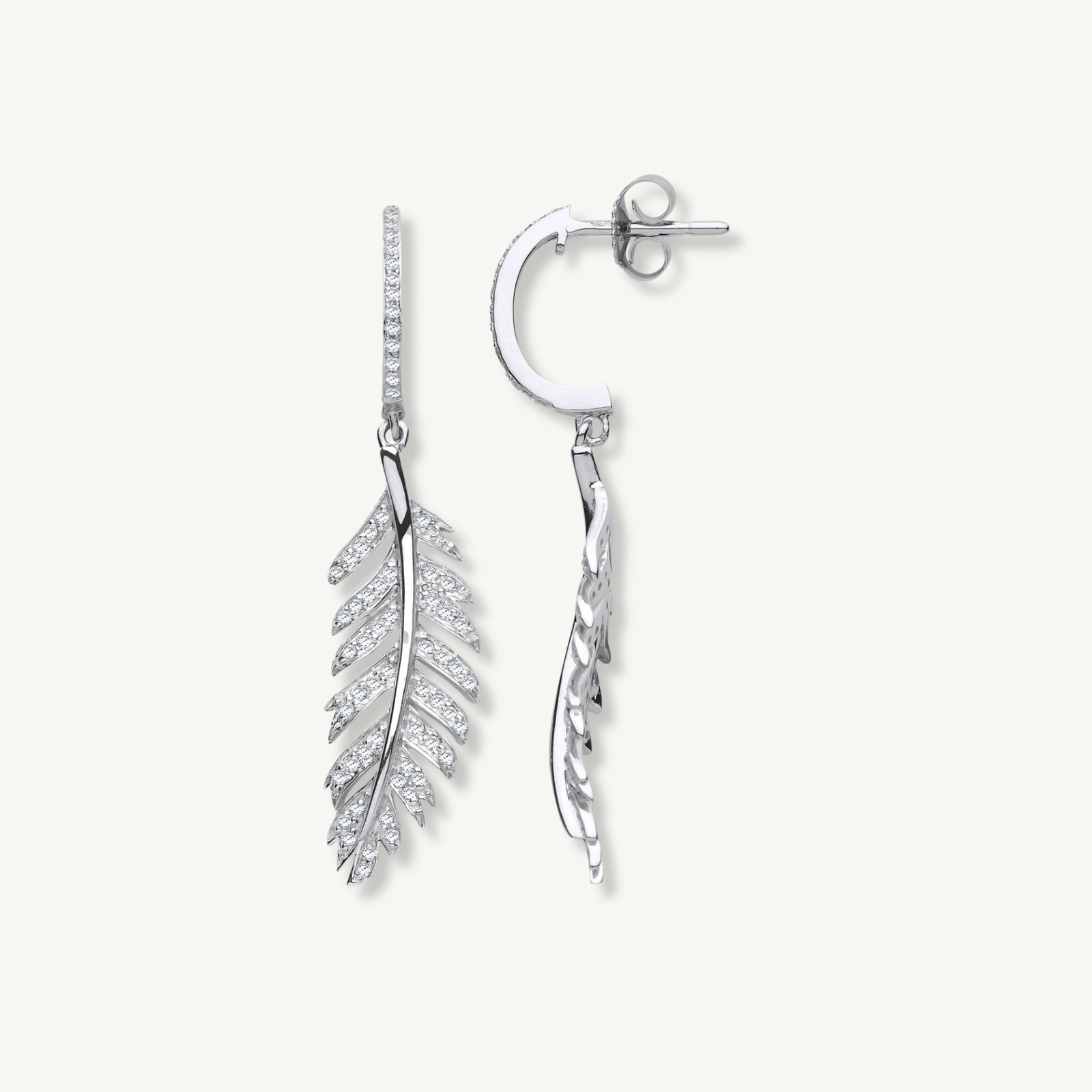 Silver feather-shaped earrings on a white background