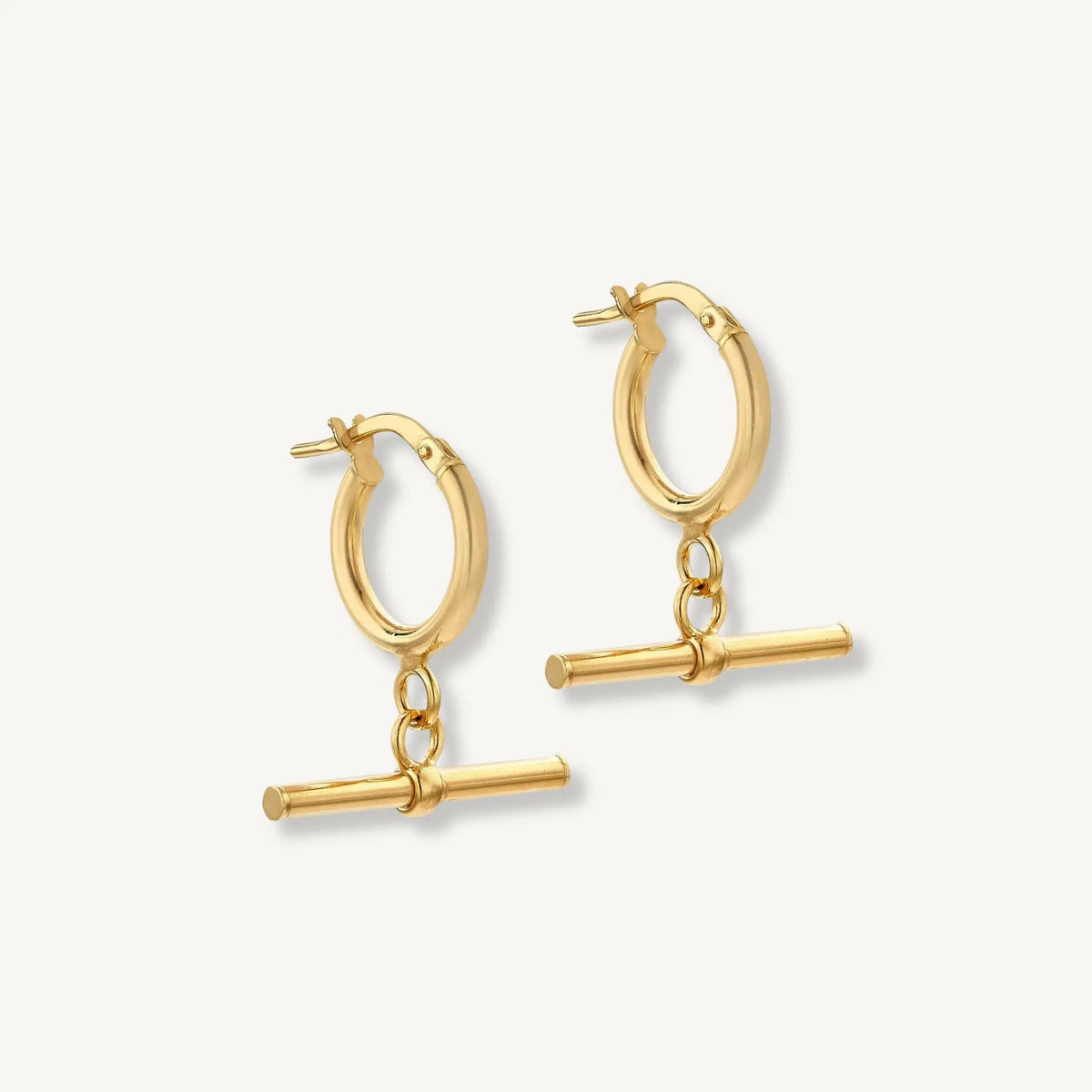 Gold hoop earrings with bar charms on a white background